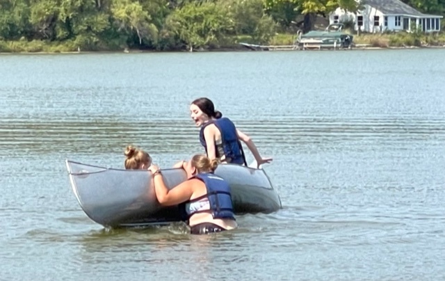 Students canoeing and swimming
