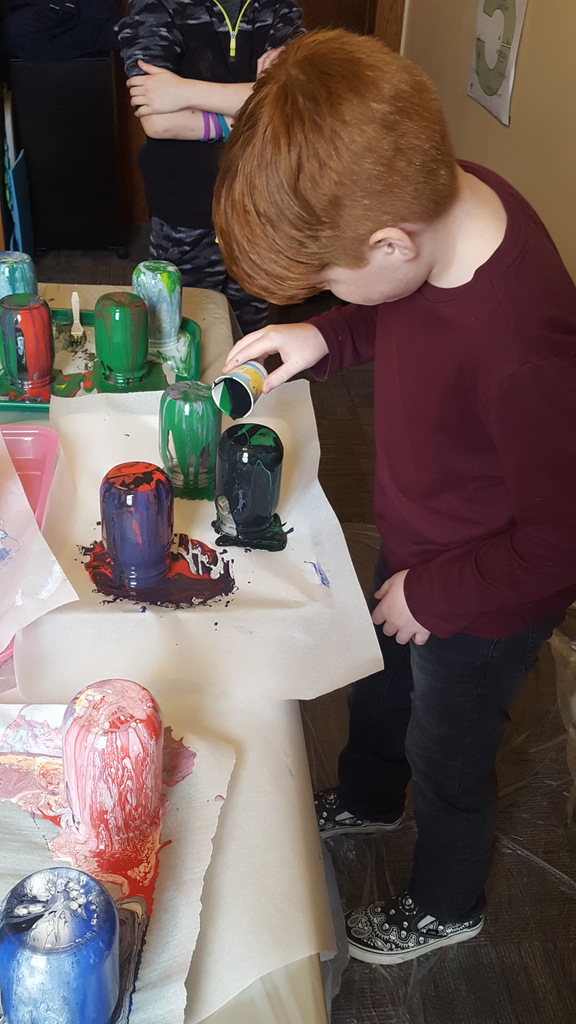 MNCS student creating a unique colorful mason jar!