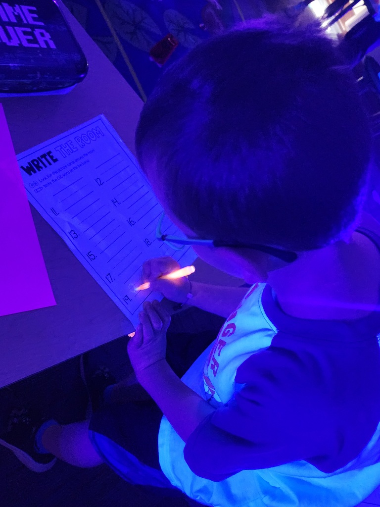 Student working on a glow in the dark scavenger hunt!